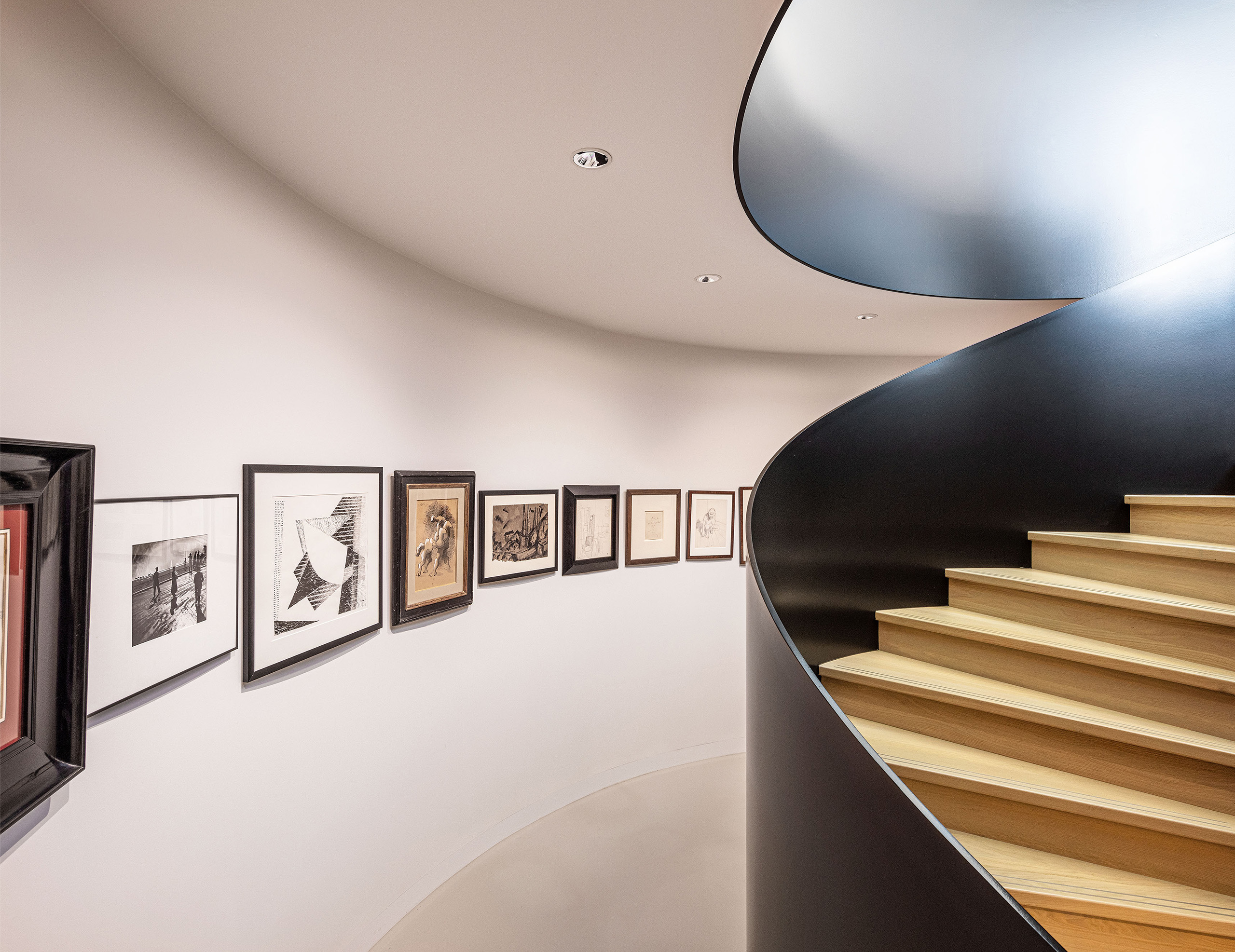 Sculptural stairs with art collection